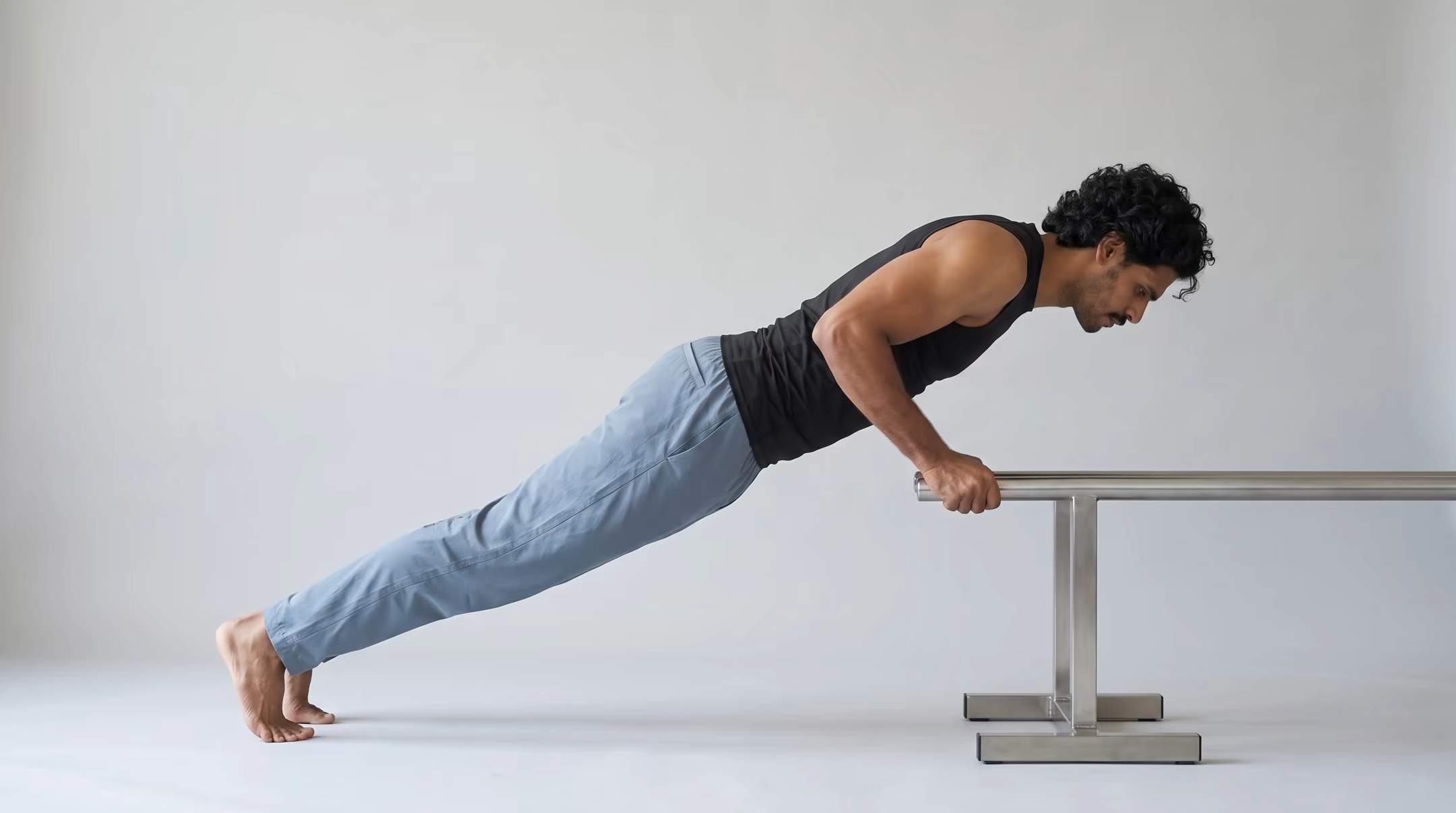 Beginner practicing an incline push-up with controlled torso alignment